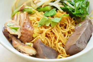 dry Chinese egg noodle with duck meat and bean sprout on bowl
