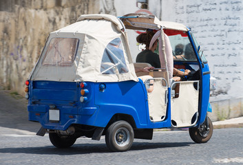Fototapeta na wymiar Auto rickshaw riding on the street.