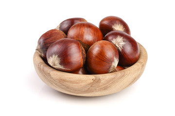 chestnut in a wooden bowl isolated on white background. Top view