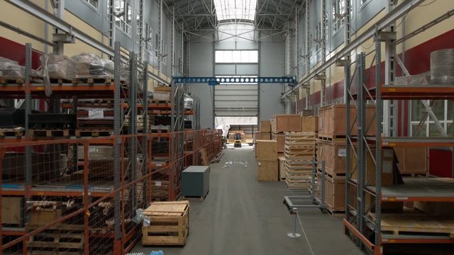 Camera cranes up on shelves of inside a storage warehouse