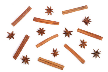 Composition of star anise and cinnamon sticks isolated on white. Abstract pattern flat lay, top view