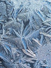 Frost on glass, ice patterns on winter glass.