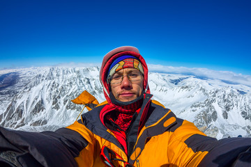 Fototapeta na wymiar Selfi male climber in the snowy mountains