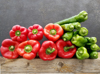 red and green peppers on wood
