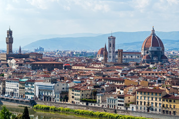 Fototapeta na wymiar Panoramic view of Florence major monuments - Florence, Tuscany, Italy. You can see Duomo Cathedral, Campanile of Giotto and Palazzo Vecchio surrounded by the typical red roofs of the town