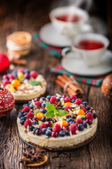 Cheesecake with fresh fruit berries strawberries raspberries and star anise. Christmas cheesecake with christmas decoration