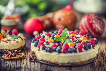 Cheesecake with fresh fruit berries strawberries raspberries and star anise. Christmas cheesecake with christmas decoration