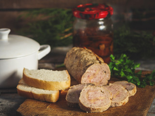 meatloaf with stuffing on a kitchen board on a wooden surface