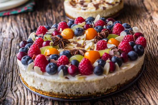 Cheesecake with fresh fruit berries strawberries raspberries and star anise. Christmas cheesecake with christmas decoration