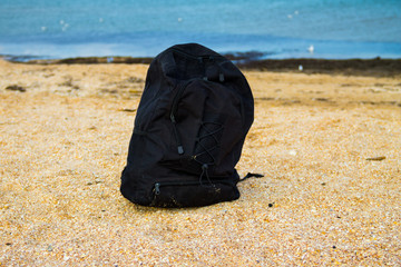 Travel backpack on summer sandy sea beach