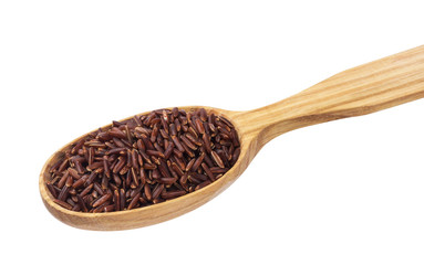 Red rice groats in wooden spoon isolated on white background