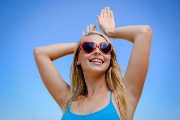 Attractive sexy blonde woman wear sunglasses posing in sunshine countryside copyspace outdoors background. Close up portrait of one caucasian joyful girl looking positive, bright emotional freshness