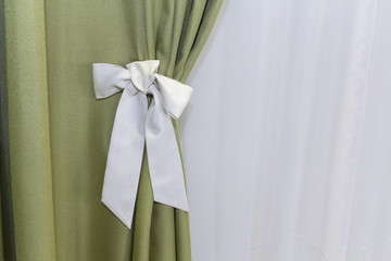 Curtains with a white bow close-up. Interior