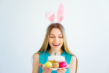 Girl with bunny ears and colored eggs