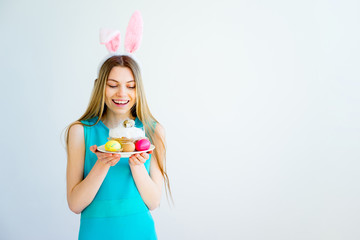 Girl with bunny ears and colored eggs