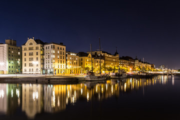 Fototapeta na wymiar Reflection of Helsinki waterfront at night in Finland