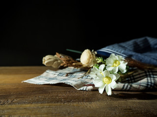 fake flower on table and black background