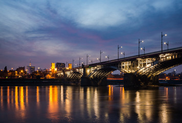 Fototapeta na wymiar Poniatowski bridge over the Vistula river at night in Warsaw, Poland