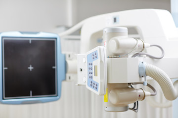 X-ray machine with control panel and scanning screen in modern clinics