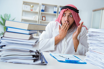 Arab businessman working in the office doing paperwork with a pi