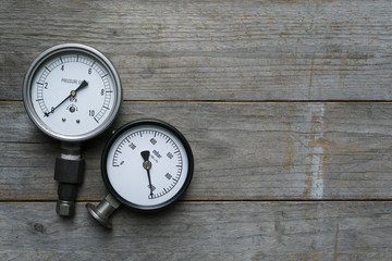 pressure gauge on wood table background