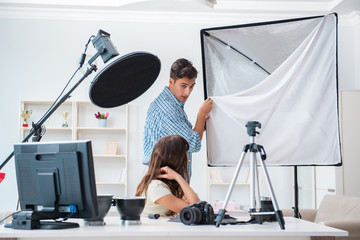 Young photographer working in photo studio