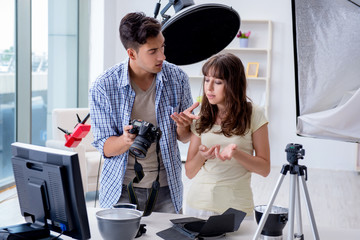 Young photographer working in photo studio