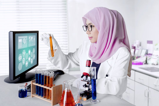 Muslim researcher with test tube in the lab