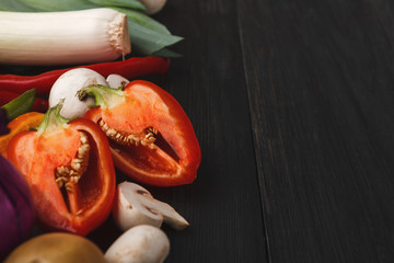 Fresh bell pepper, mushrooms and leek on wooden background