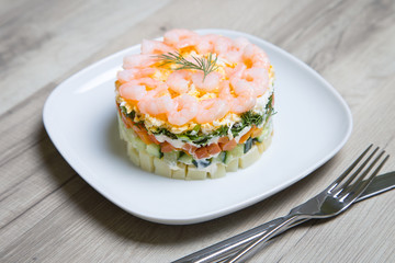 Salad with shrimps on a white plate. Selective focus, close-up.