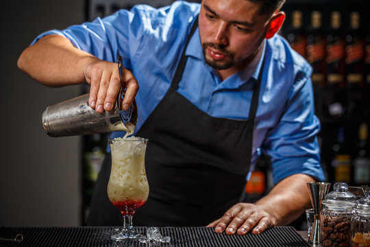 Male bartender is making cocktail