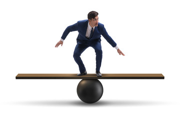 Businessman balancing on seesaw in uncertainty concept
