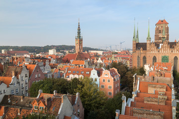 Old residential buildings, Main Town Hall's tower and St. Mary's Church at the Main Town (Old Town) in Gdansk, Poland, viewed from above in the morning.