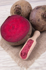 Healthy beetroot juice and fresh vegetables on wooden background. - 180448659