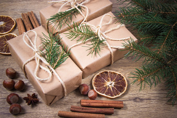Christmas gifts in rustic boxes on wooden background.