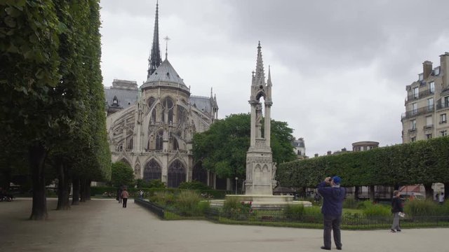Tourist photographing famous medieval Notre-Dame de Paris, France sightseeing
