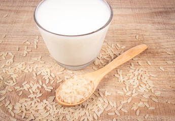 Rice milk on the wooden background .