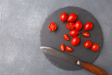 Rustic slate stone plate with tomatoes, cooking backgroung
