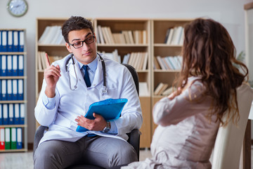 Fototapeta premium Pregnant woman visiting doctor for consultation