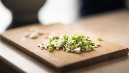 Fresh green onions on a cutting board.