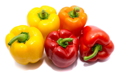 Group of peppers, two yellow, two red and one orange pepper, isolated on white background.