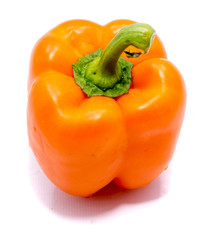 One orange pepper on back, isolated on white background.