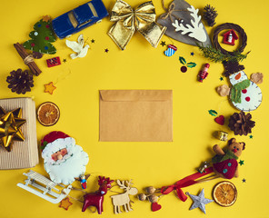 A lot of Christmas decorations and toys  with Christmas letter on yellow background. Space for text. Design mockup