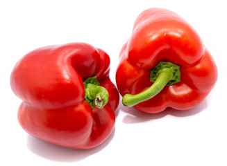 Group of red peppers, one pepper on back, isolated on white background.