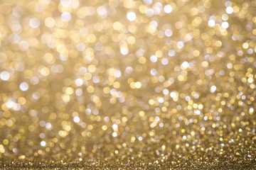 Gold Abstract Christmas twinkled bright background with bokeh defocused lights . Lights Festive background concept.