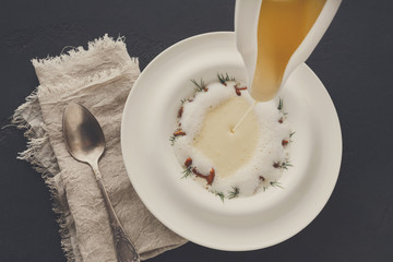 Pouring broth to mushroom cream soup top view