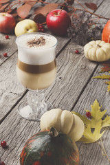 Pumpkin spice latte. Coffee cup on white wood background