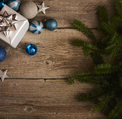 Christmas decorations and gift boxes over wooden board