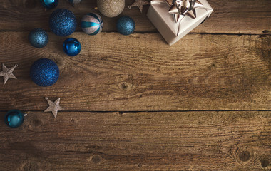 Christmas decorations and gift boxes over wooden board