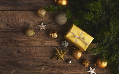 Christmas decorations and gift boxes over wooden board